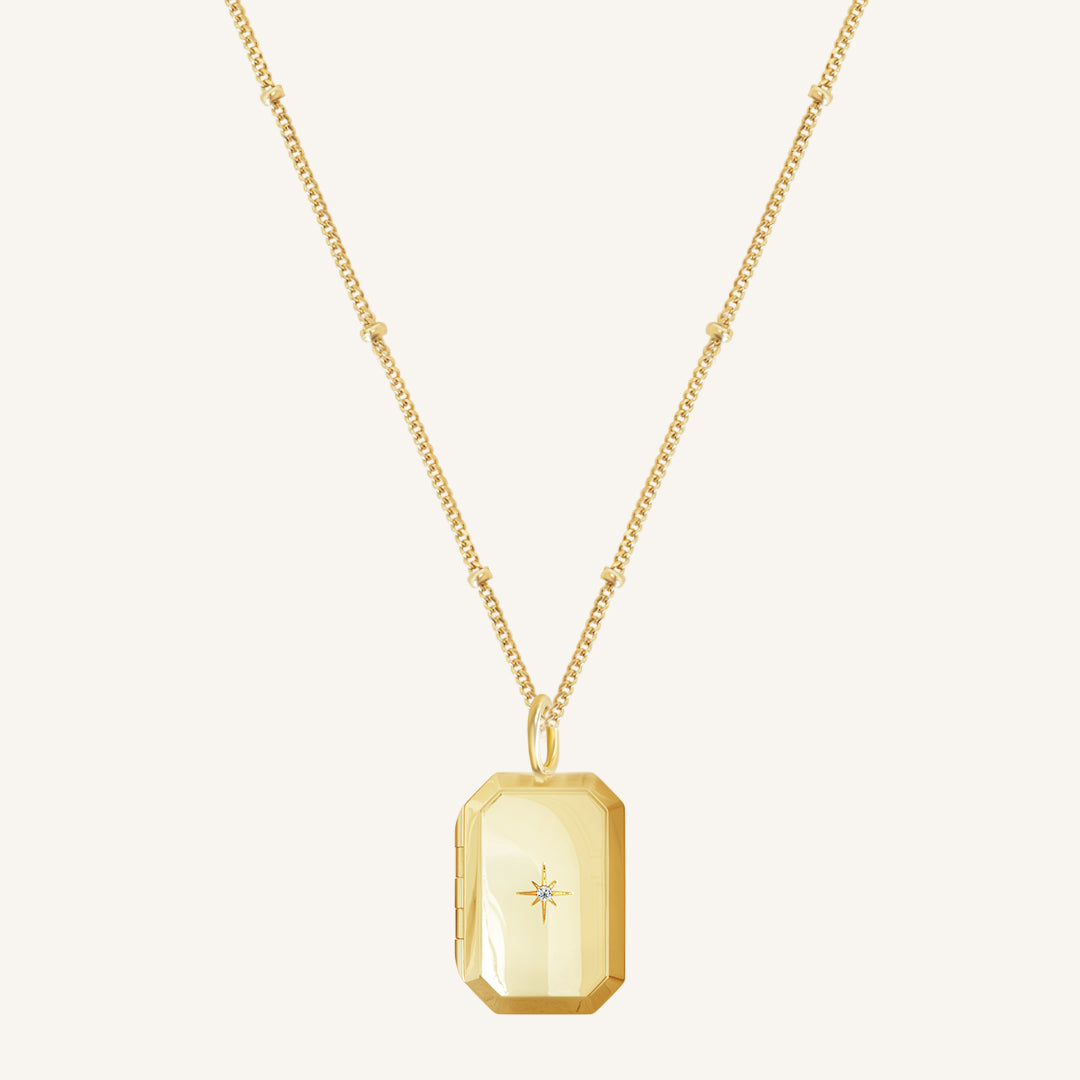 Gold Bevel Locket on bobble chain on white background
