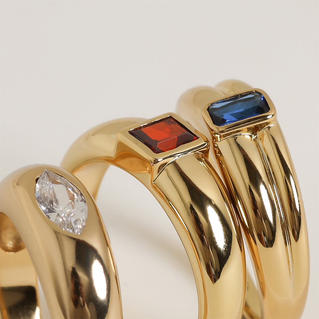 Gold ring with Navy blue cubic zirconia bezel set Inspired by the halls of Versailles close up on white background