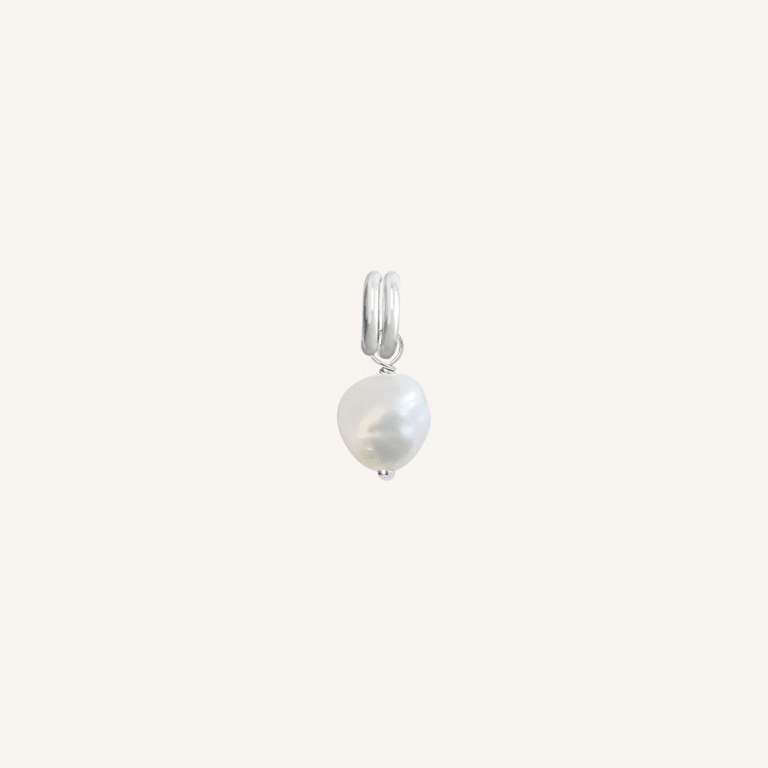 A petite pearl charm with silver findings