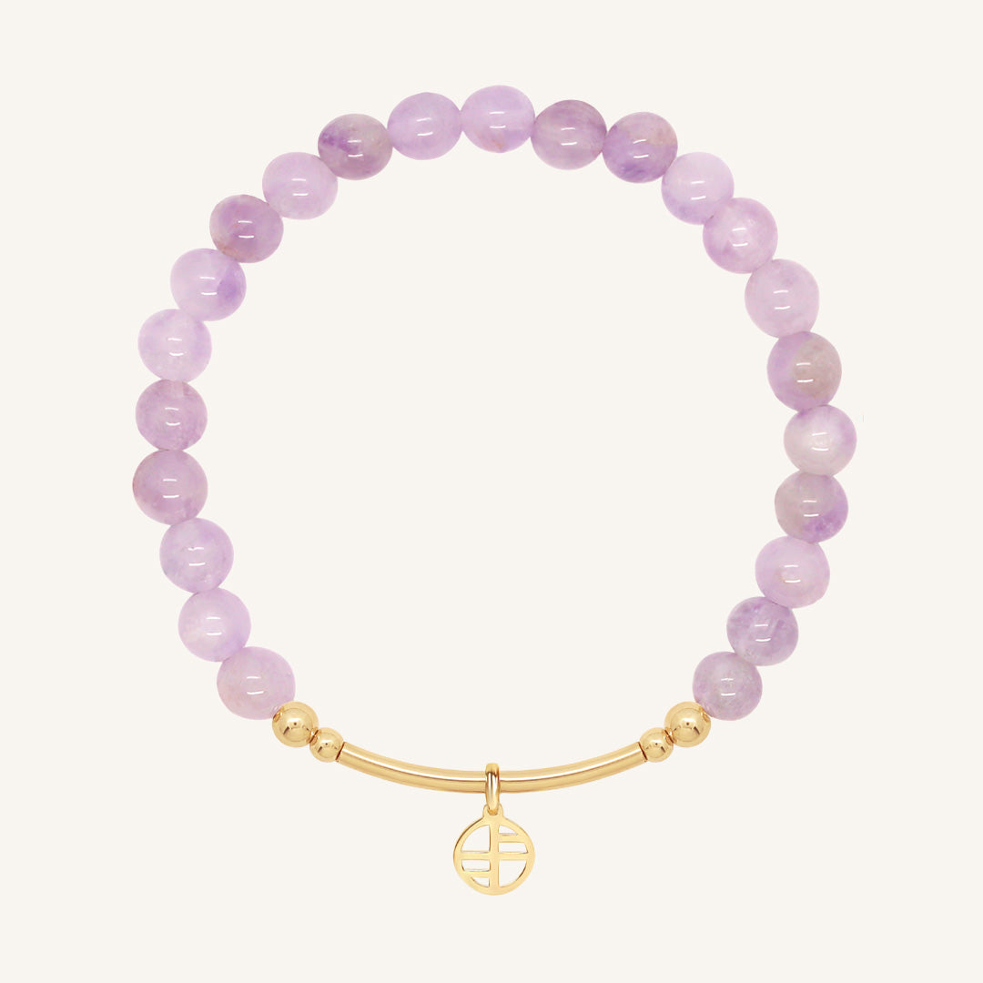 Purple beaded bracelet with a gold clasp on a white background