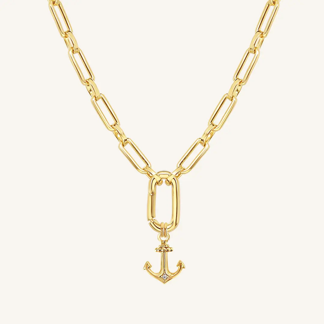 A gold-tone anchor necklace with a small, detailed anchor pendant on a chain.