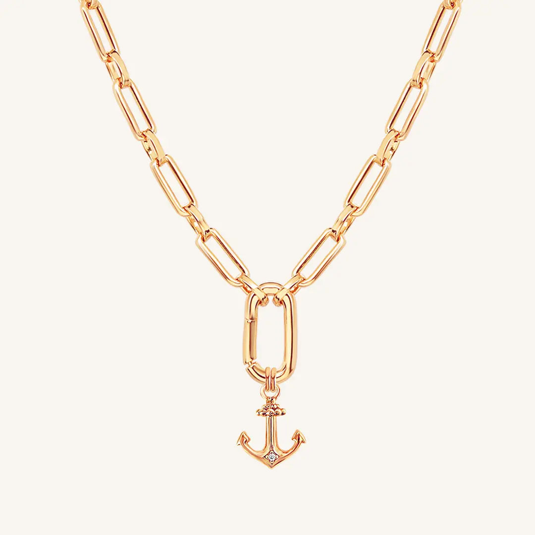 A rose-tone anchor necklace with a small, detailed anchor pendant on a chain.