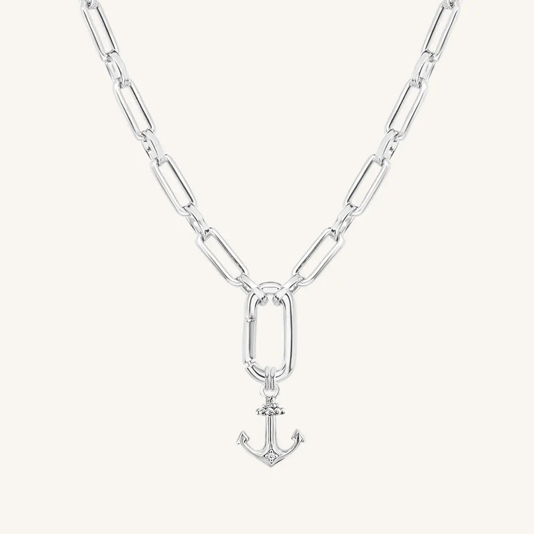 A silver-tone anchor necklace with a small, detailed anchor pendant on a chain.