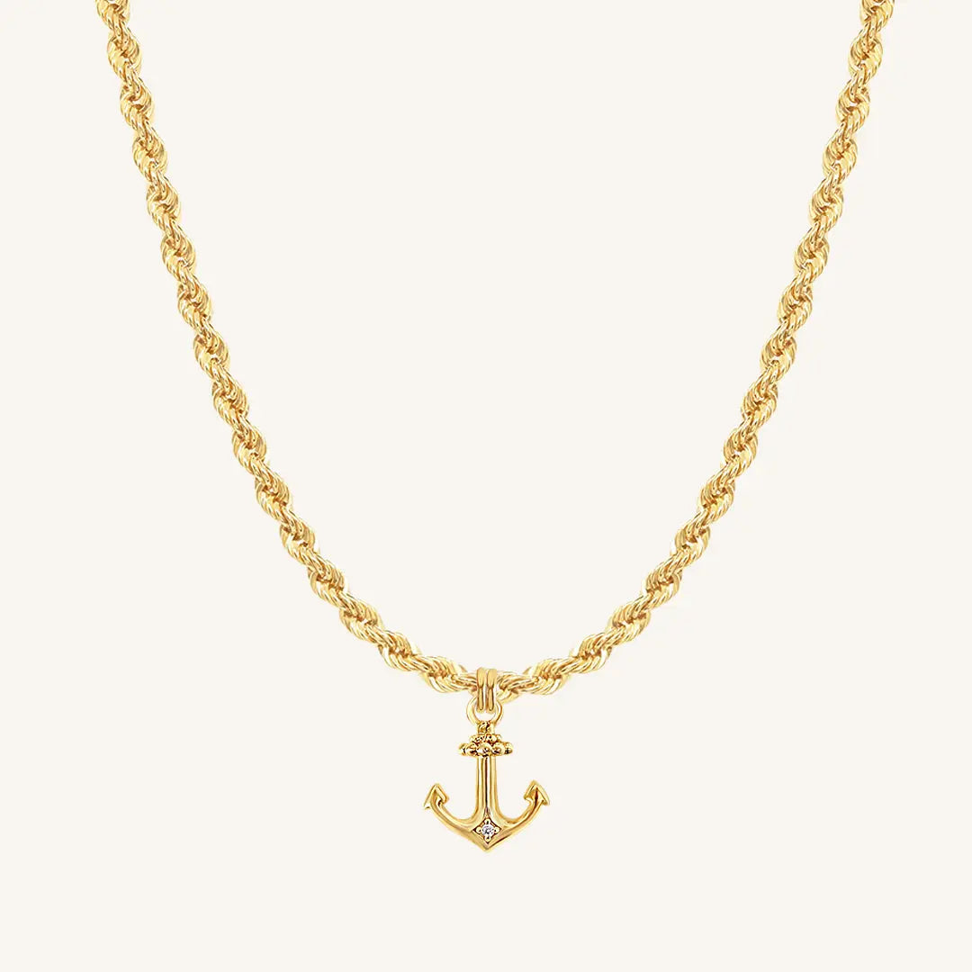 A gold-tone anchor necklace with a small, detailed anchor pendant on a chain.