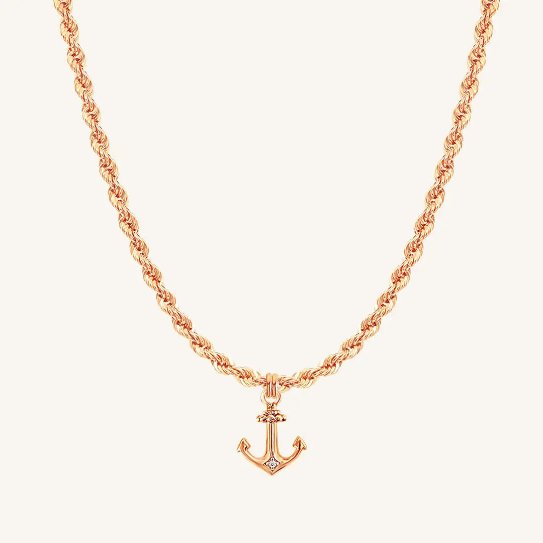 A rose-tone anchor necklace with a small, detailed anchor pendant on a chain.