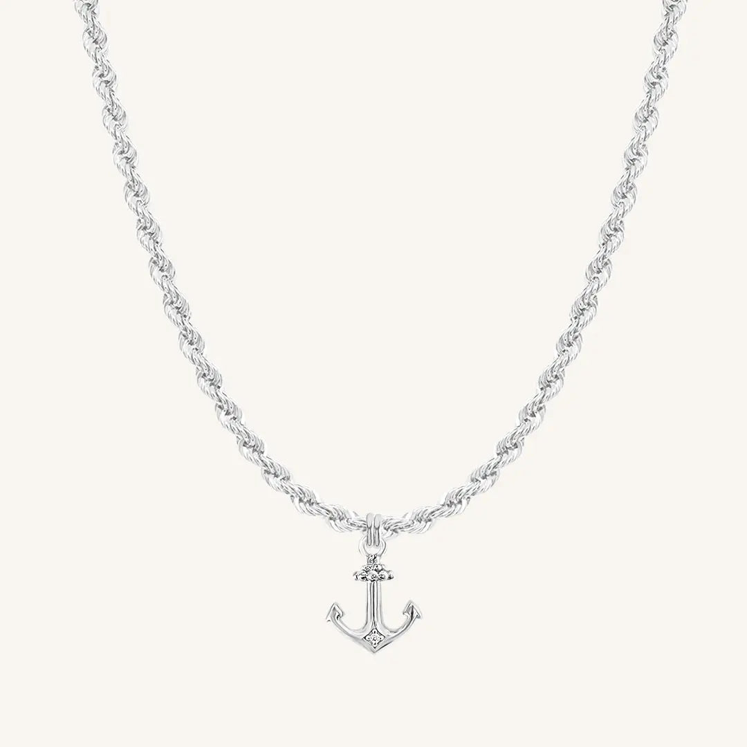 A silver-tone anchor necklace with a small, detailed anchor pendant on a chain.
