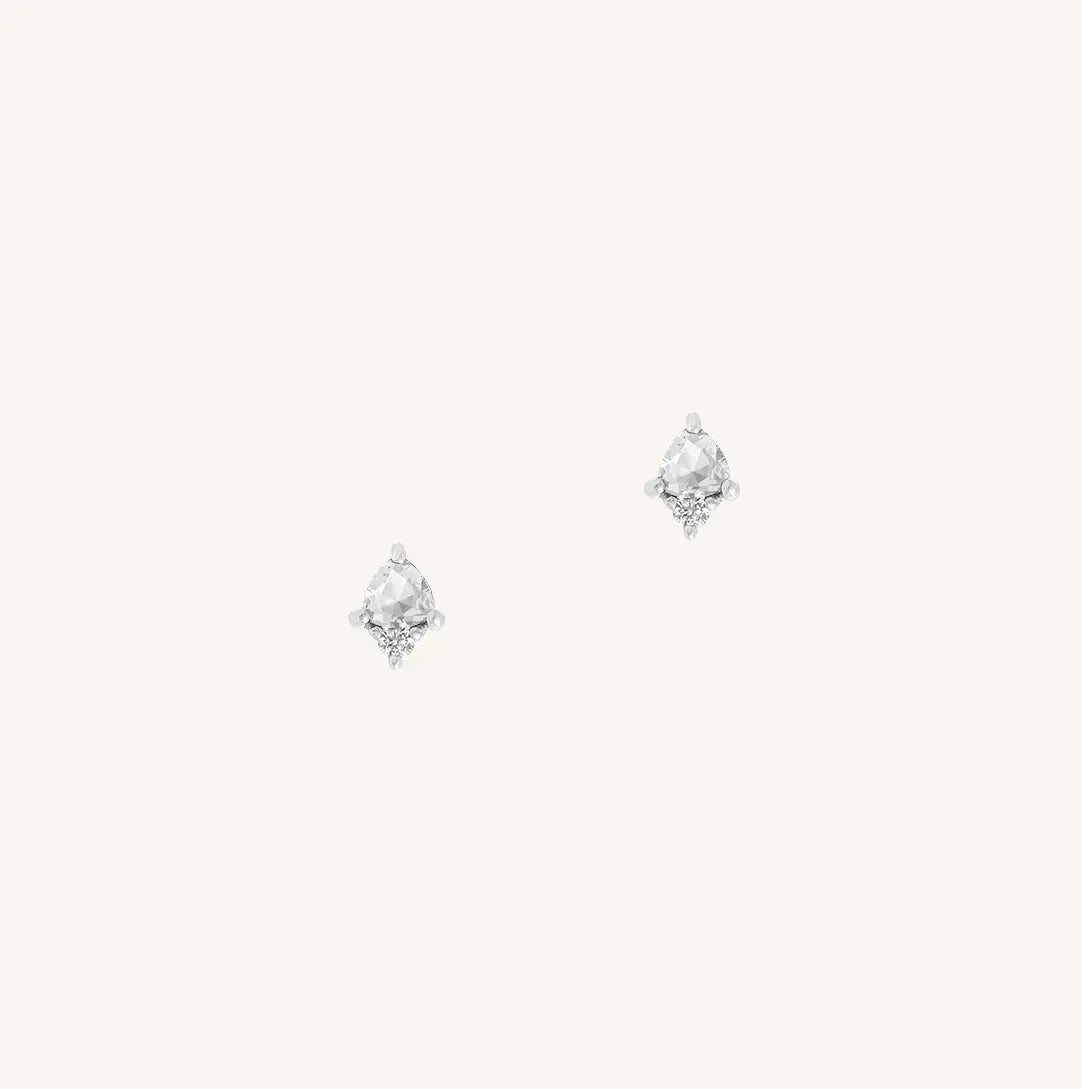 A silver pair of stud earrings featuring a white cubic zirconia, representing April.