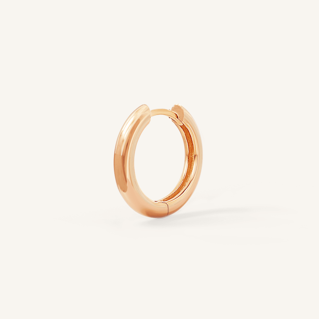 A rose hoop earring on a white background