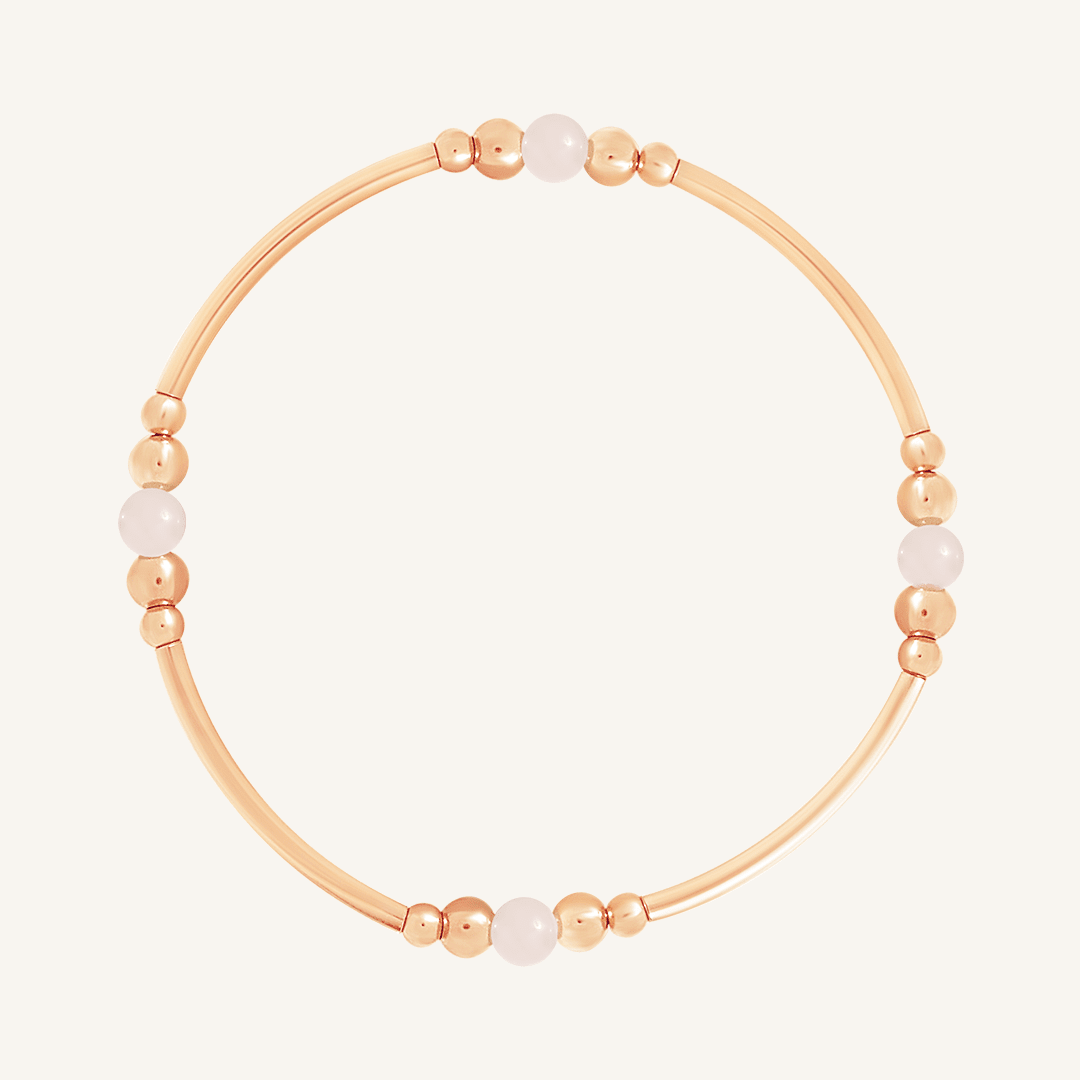 A rose-tone beaded bracelet with rose quartz stones