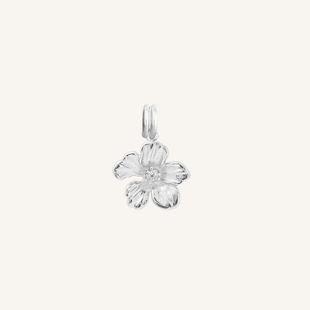 A silver-colored metal charm in the shape of an Azalea flower.