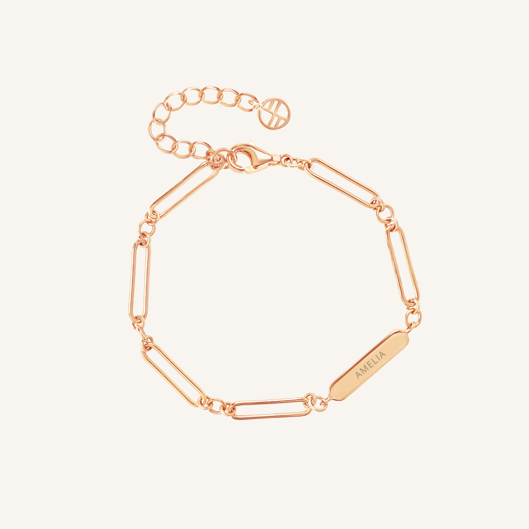 A rose-tone bracelet with a chain design and an engraving bar, displayed against a white background, made for children
