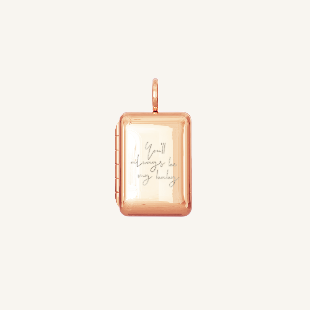 A rose gold locket with a laser engraved inscription of 'You'll always be my baby'