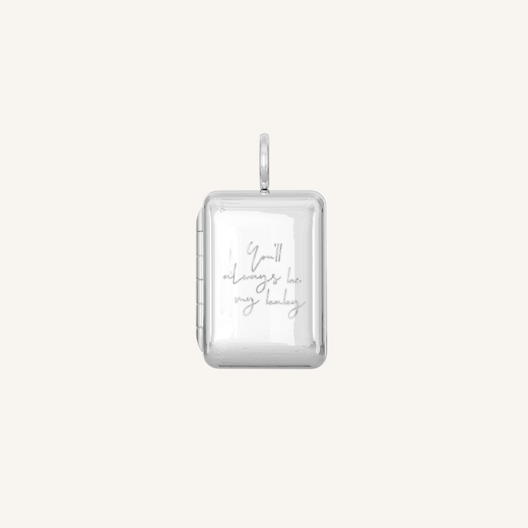 A silver locket with a laser engraved inscription of 'You'll always be my baby'