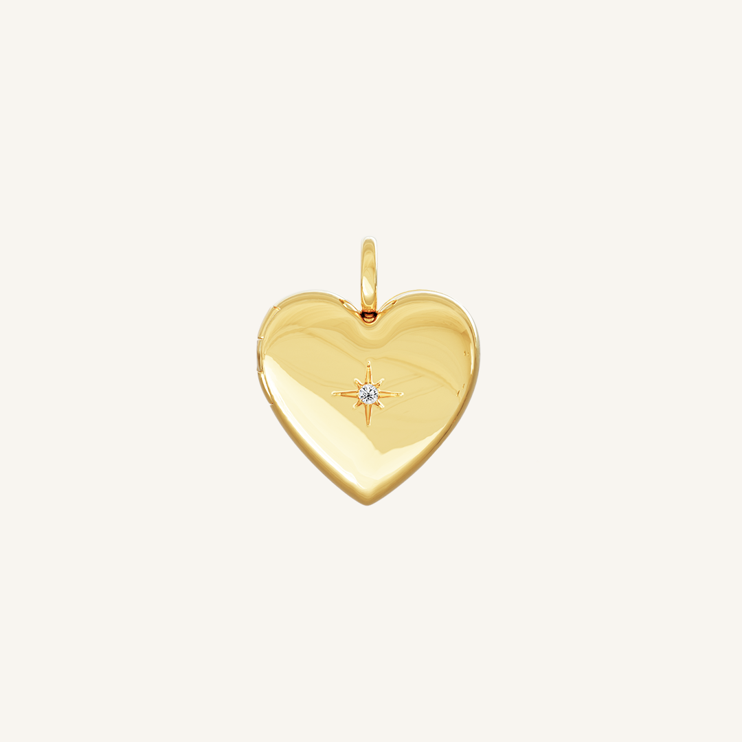 A gold heart-shaped photo locket closed close up