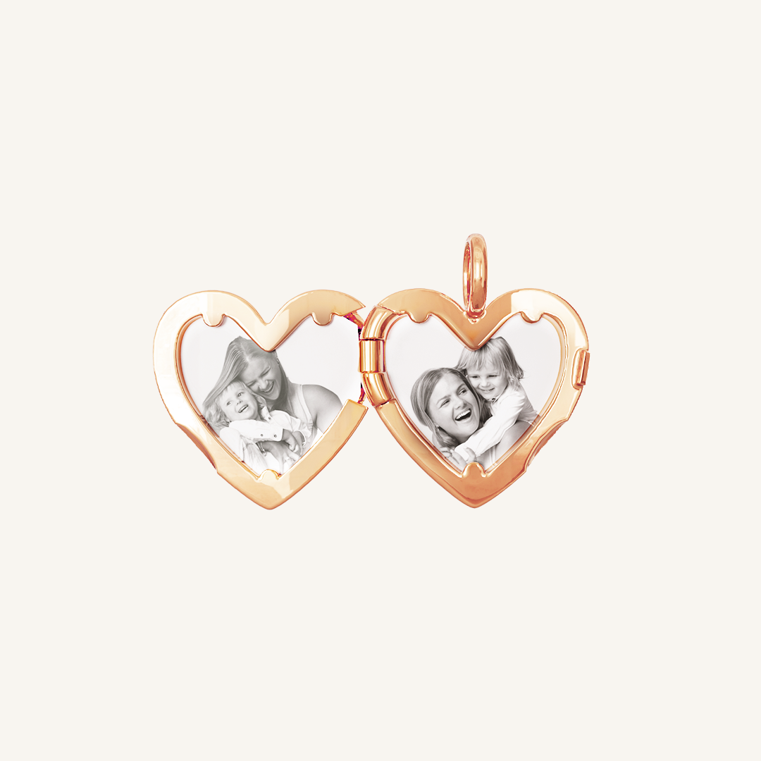 A rose heart-shaped photo locket with two images inside