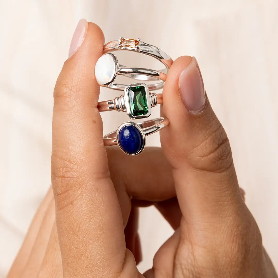 A silver ring with a deep-blue lapis stone set in a thinner band closer up