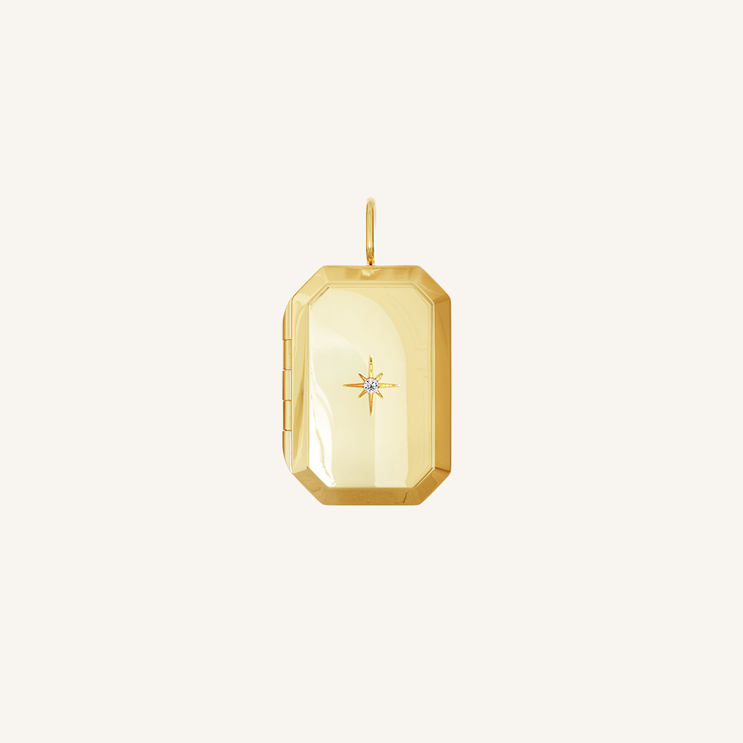 A gold bevel photo locket featuring a cubic zirconia in the centre