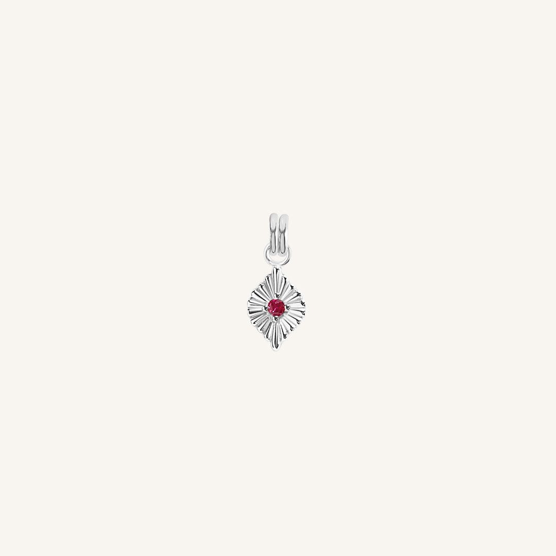 A silver birthstone charm with a ruby cubic zirconia representing the month of July.