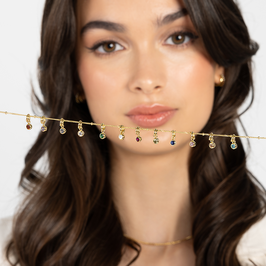 Round birthstone charms lined up from January to December on a chain