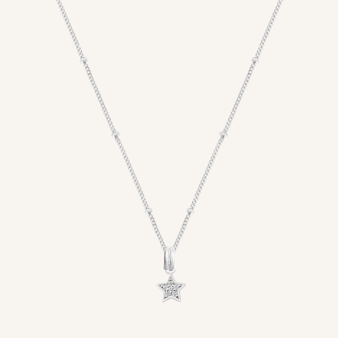 A silver necklace featuring a star-shaped charm pendant with cubic zirconias in the centre.