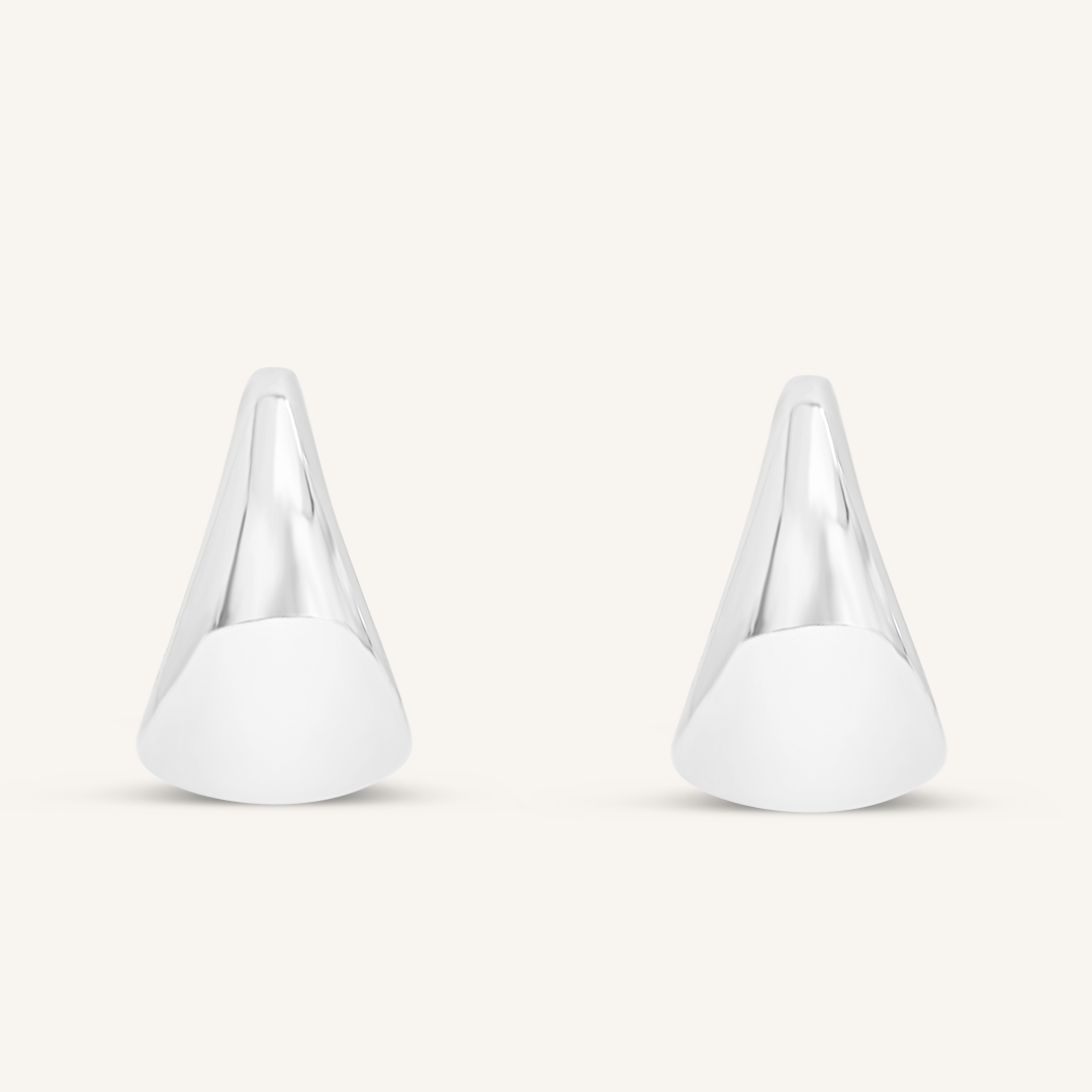 A pair of silver chunky hoop earrings on a white background.