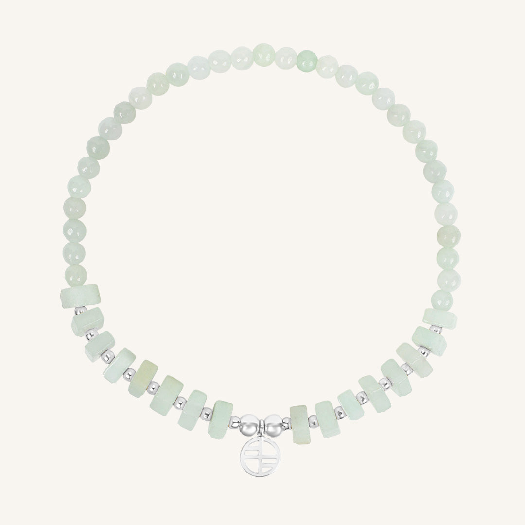 Bracelet with light green beads on a white background