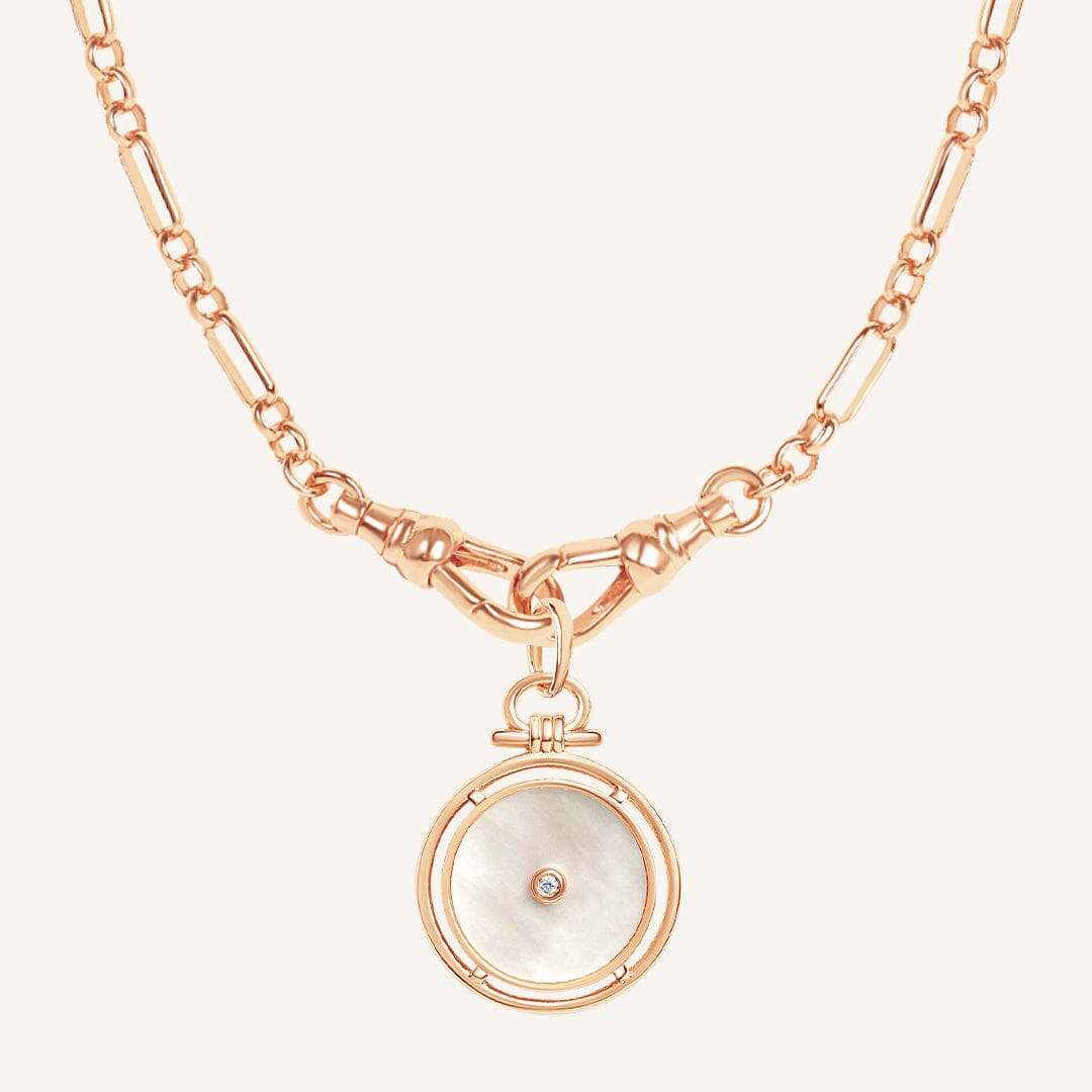 Rose gold necklace with a circular pendant on a white background