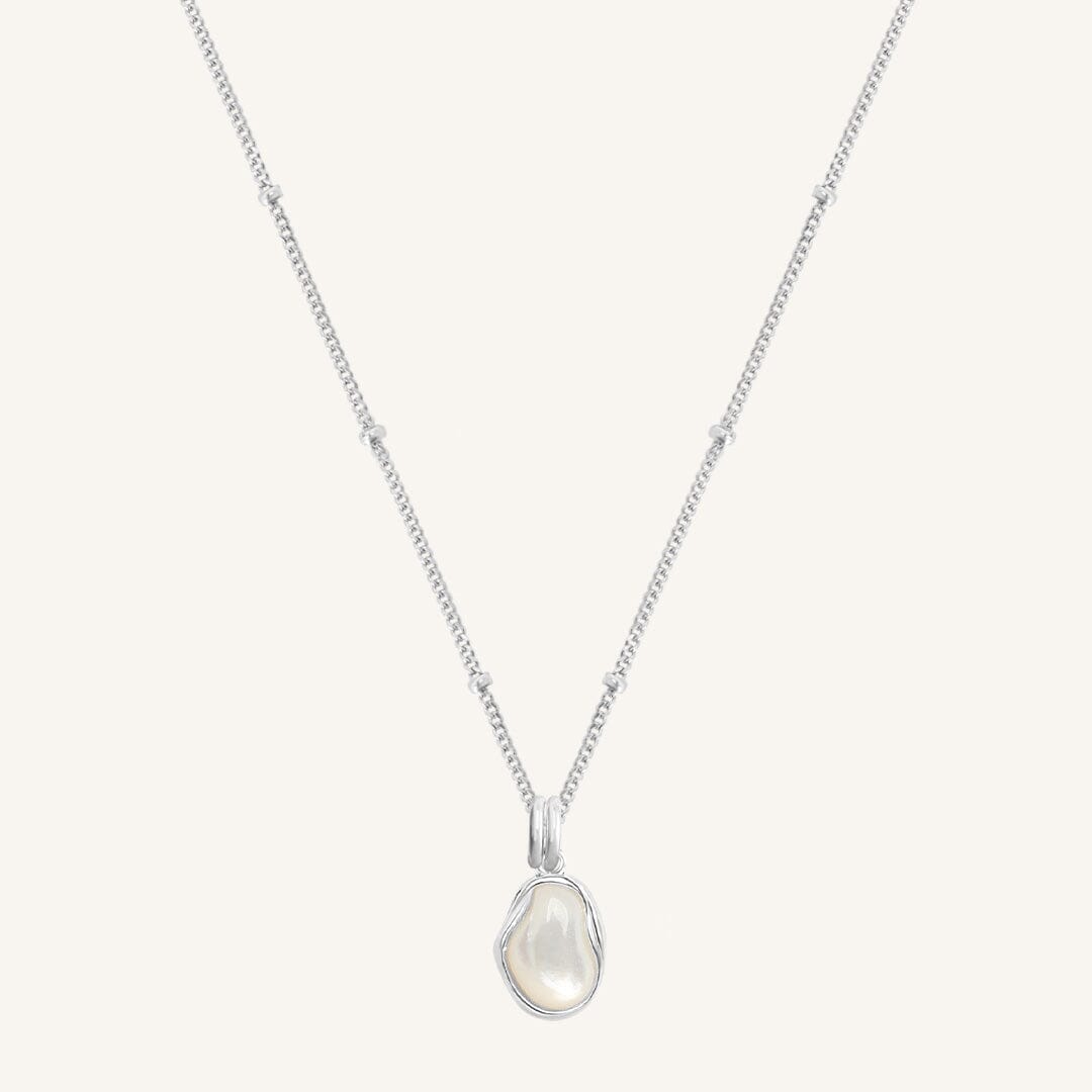 Silver necklace with a teardrop-shaped pendant on a white background