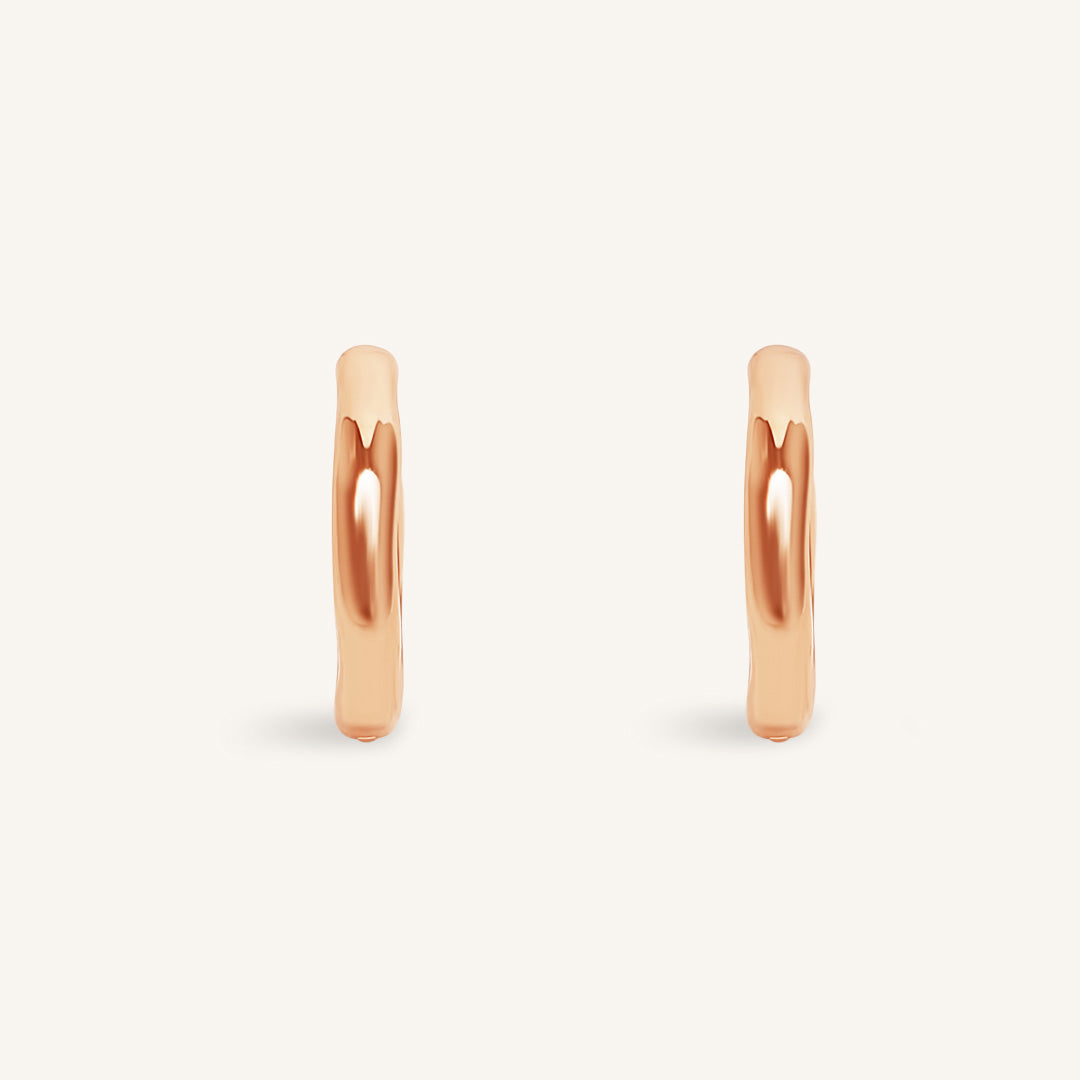 Rose gold hoop earrings on a white background