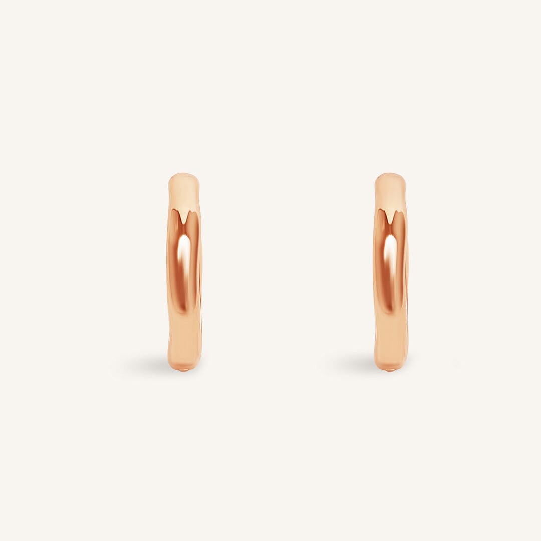 Rose gold hoop earrings on a white background