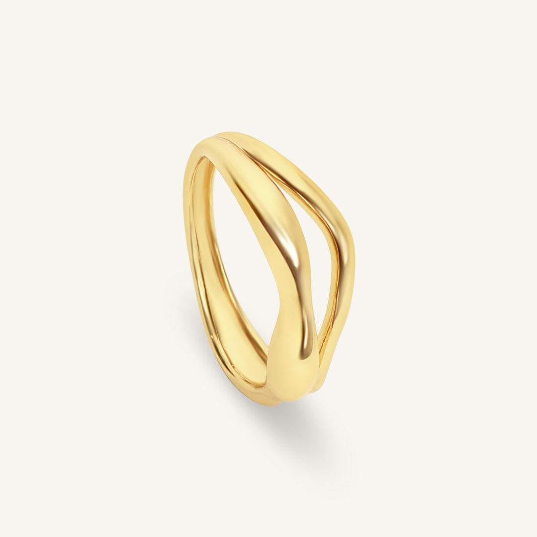 Gold ring on a light beige background