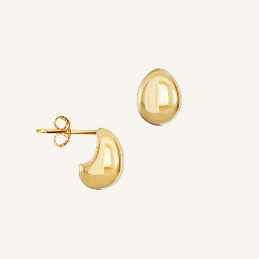 A pair of chunky bulb-shaped earrings in gold tone.