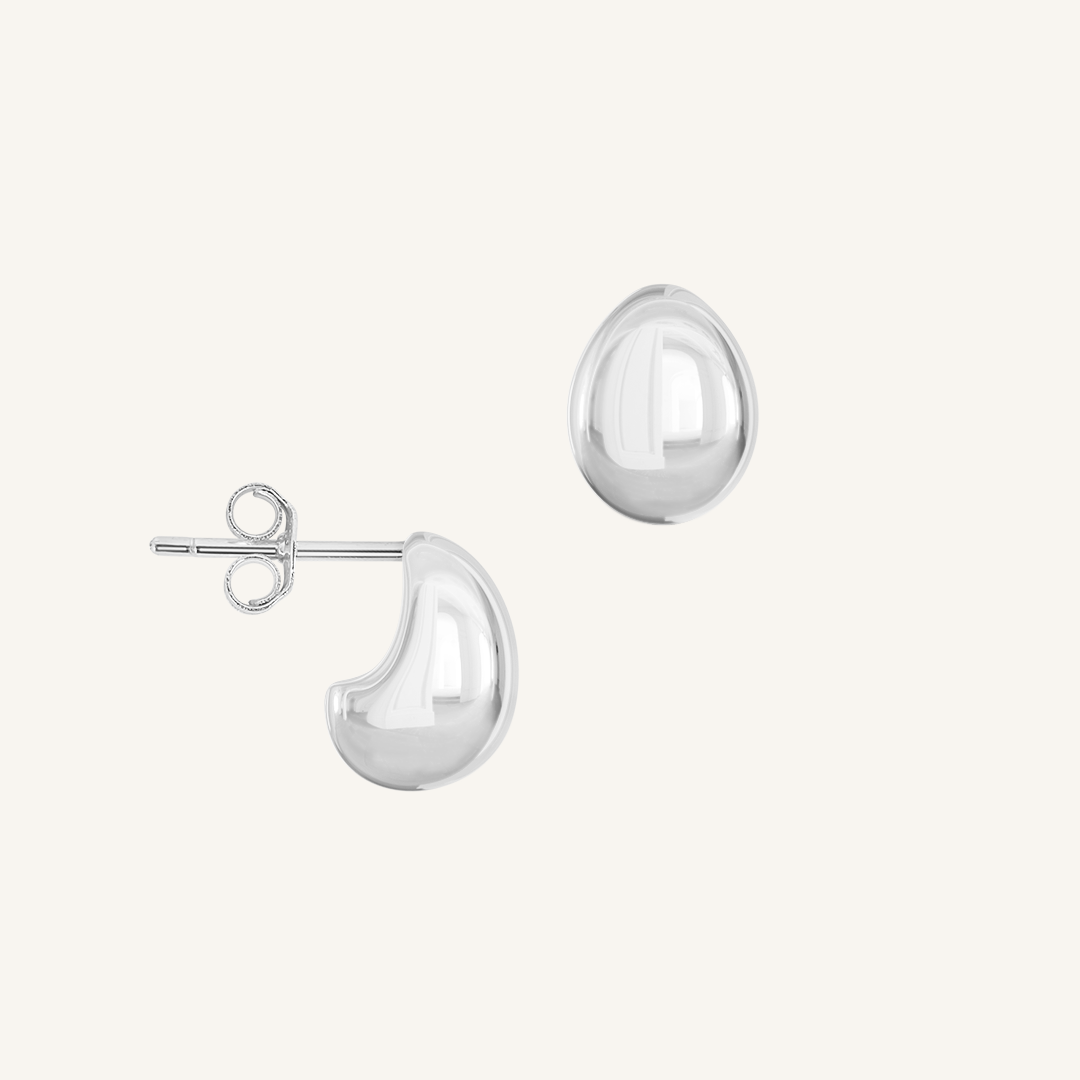 A pair of chunky bulb-shaped earrings in silver tone.