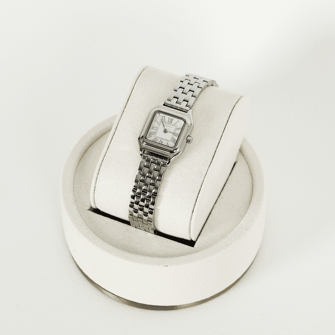 A silver-toned Louis Watch with a link bracelet and a square face featuring Roman numerals.