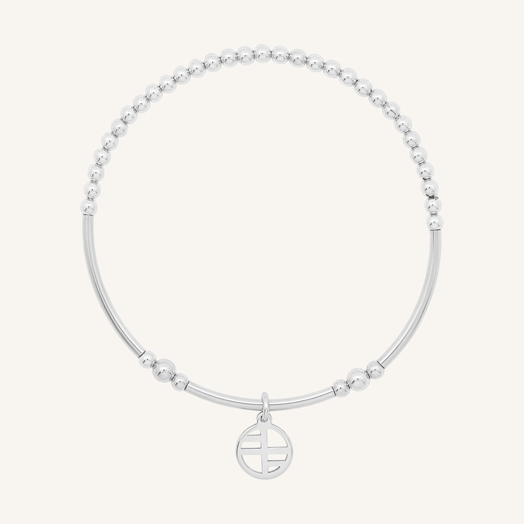 A silver-tone charm bracelet with a beaded design and a charm pendant in the centre.