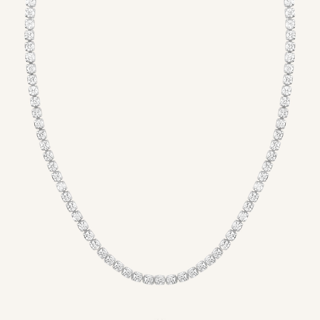 A tennis chain necklace with silver metal tone.