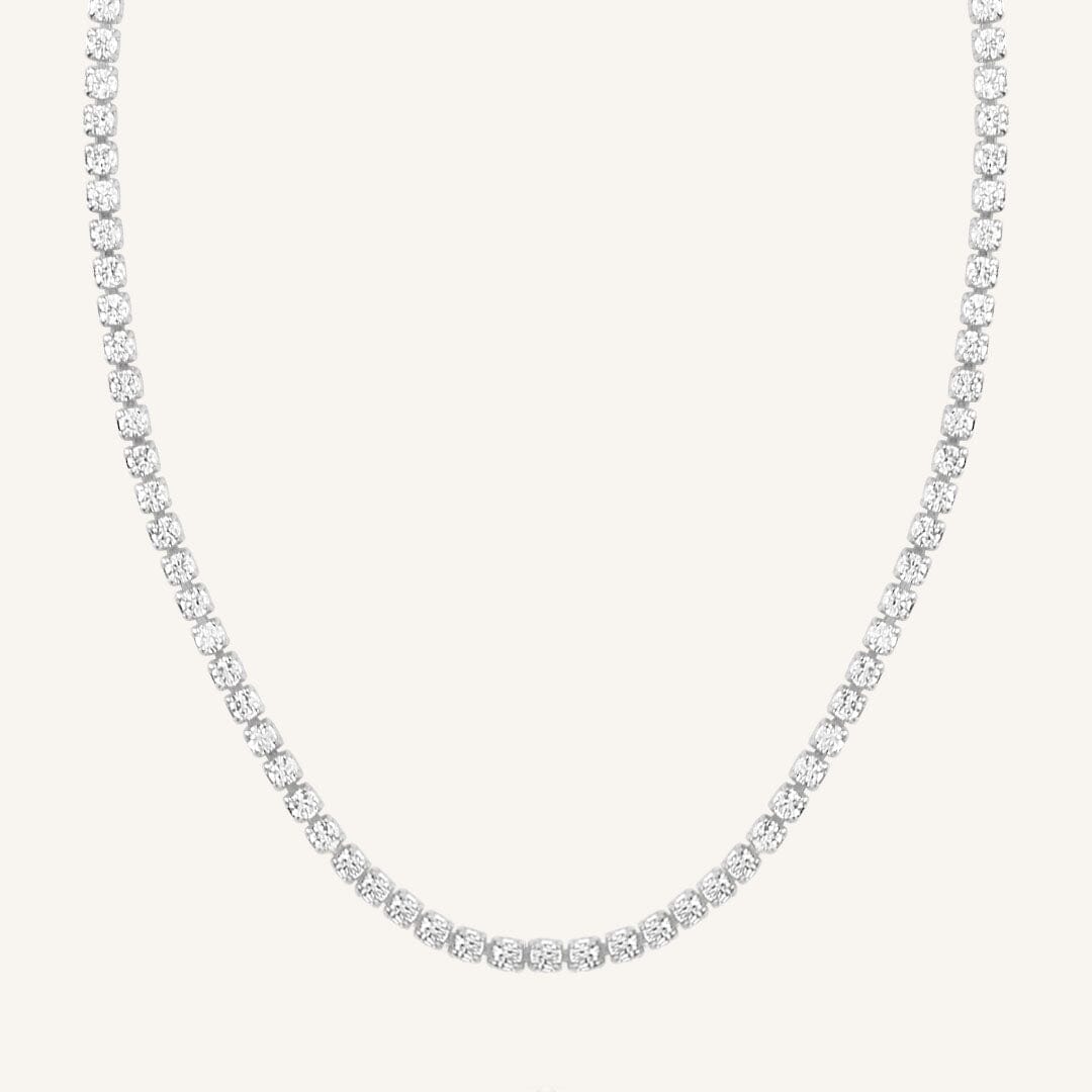 A tennis chain necklace with silver metal tone.