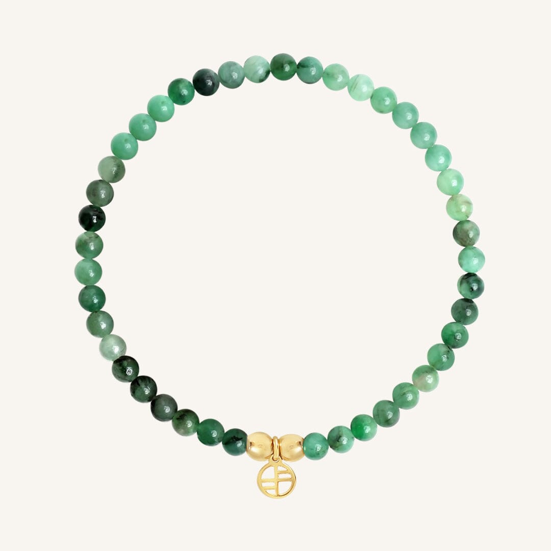 Green beaded bracelet with a gold clasp on a white background