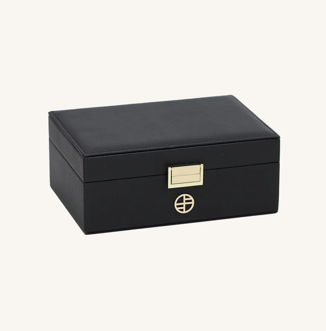 A black jewellery box with a lid, open sections for storing jewellery, and a necklace rack inside.