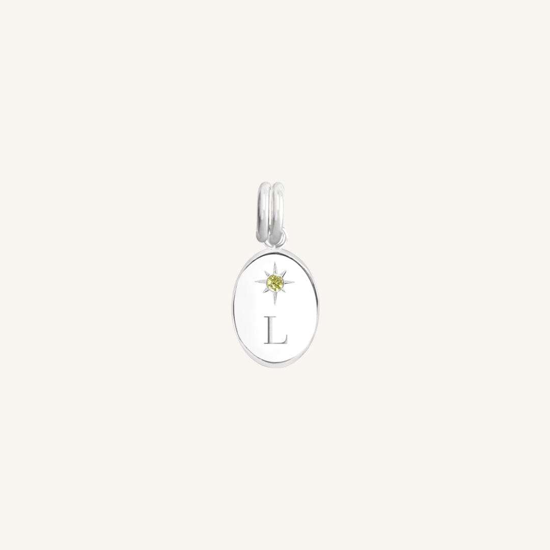 Silver pendant with a yellow gemstone and letter 'L' on a white background