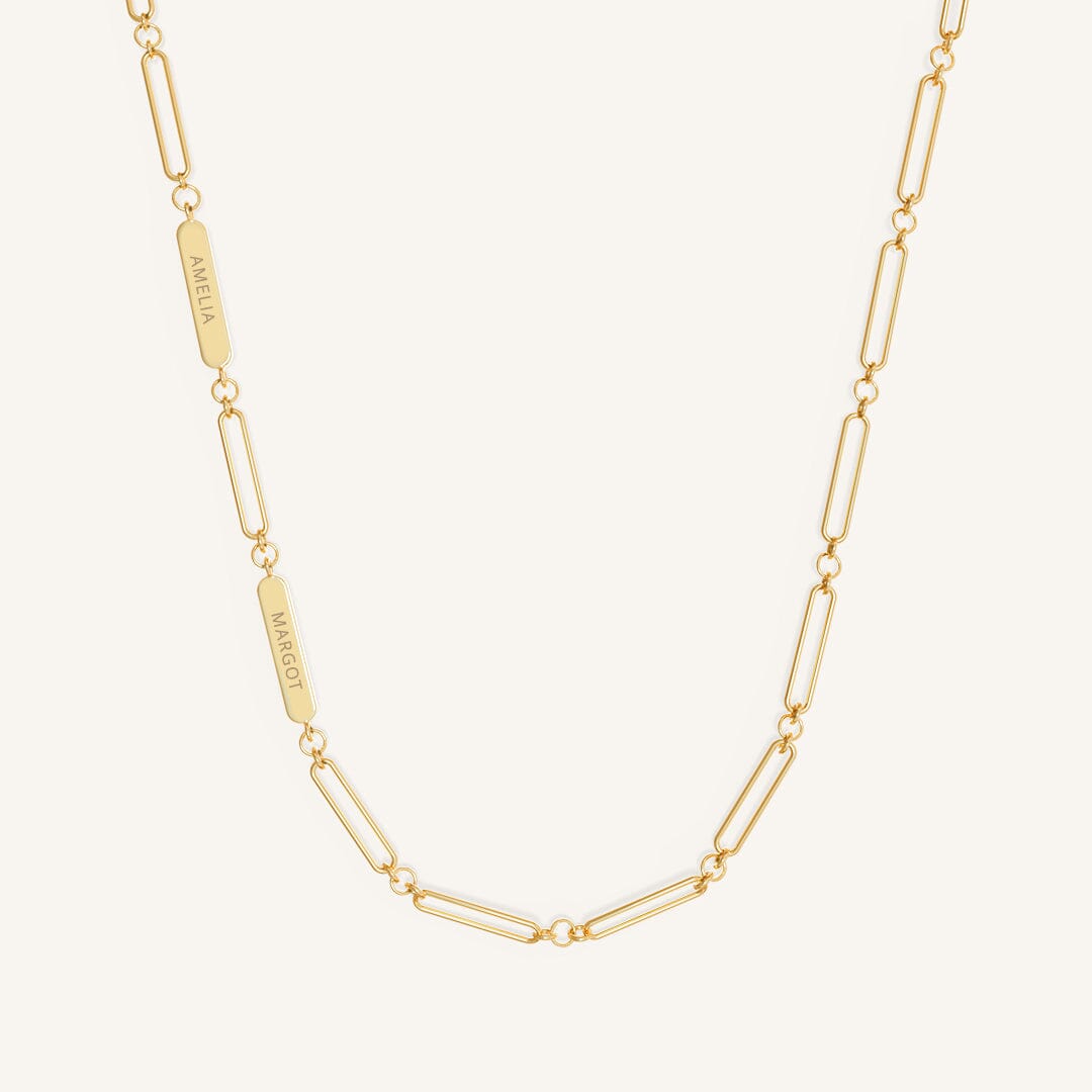 A gold chain necklace with two engraveable panels on a white background