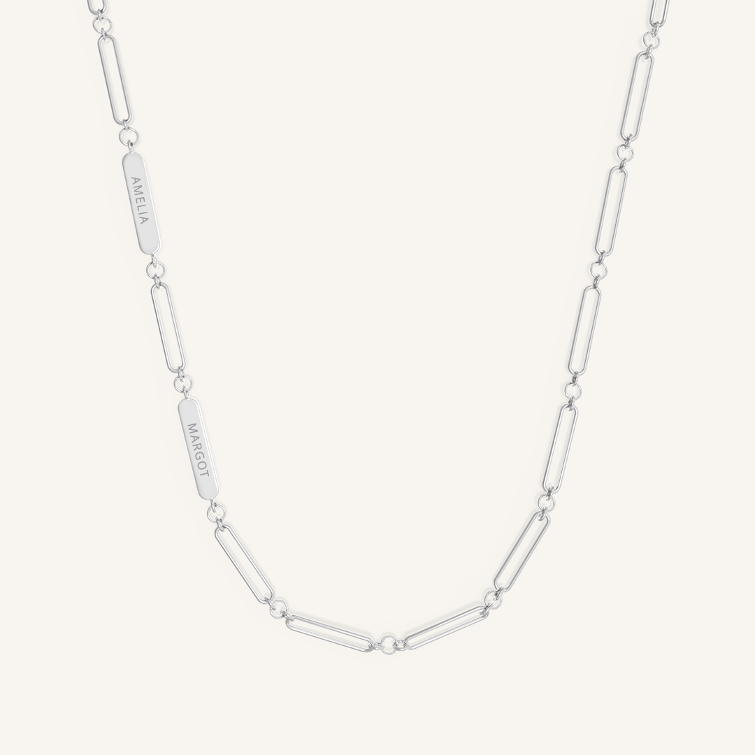 A silver chain necklace with two engraveable panels on a white background