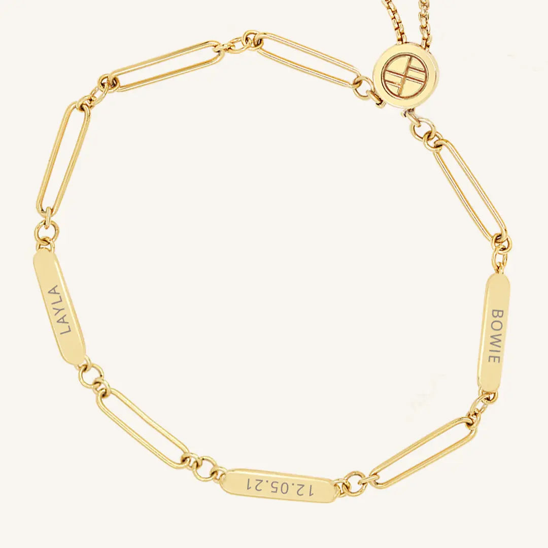 A gold Etch chain bracelet with three panels for engraving, featuring an adjustable fastening mechanism.