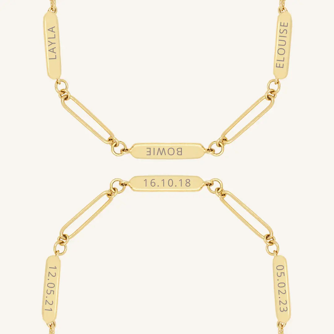 A gold Etch chain bracelet with three panels for engraving, close up