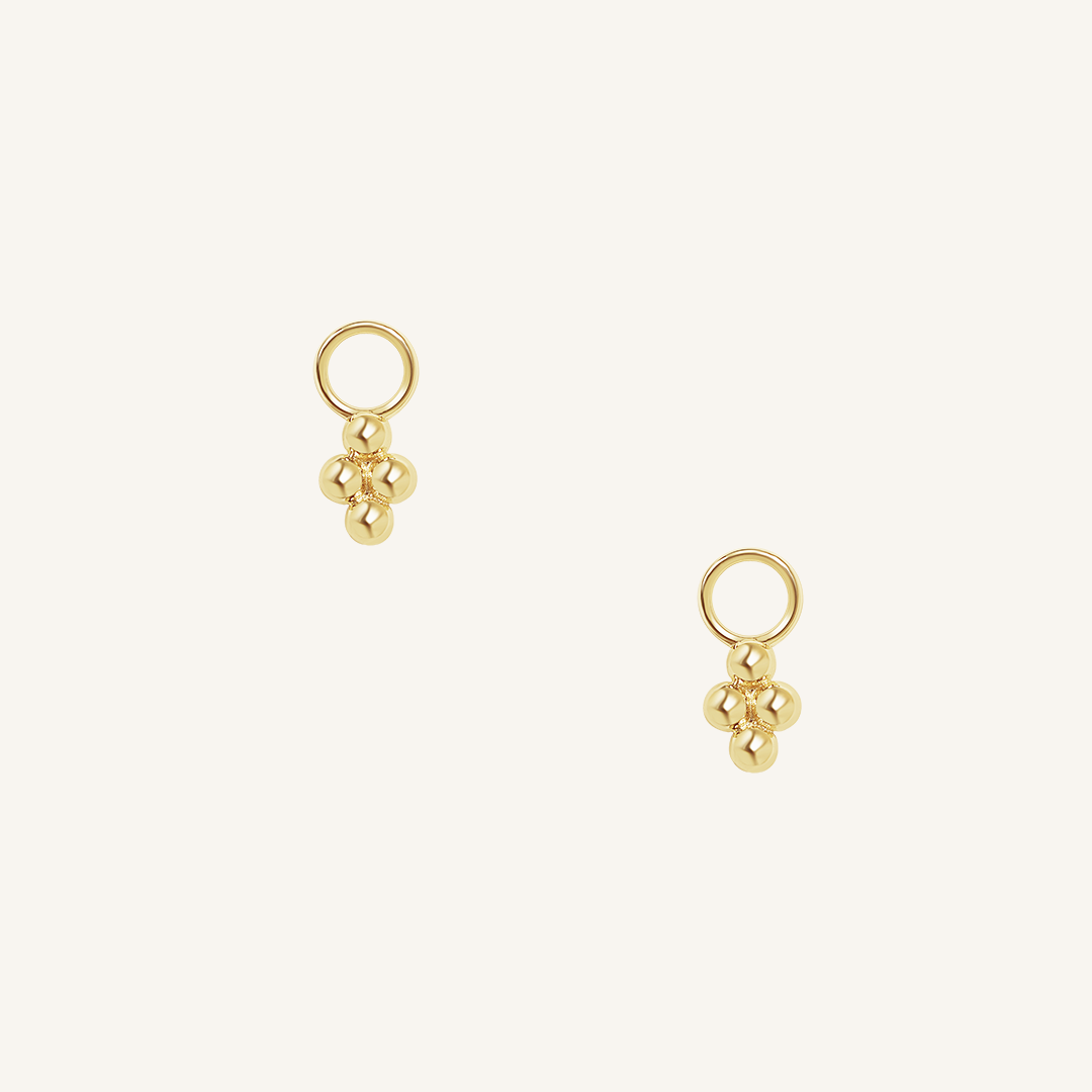 A set of two hoop charm earrings, featuring petite bobble details.