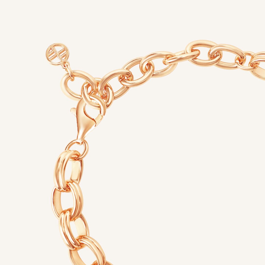 Rose gold chain bracelet on a light beige background