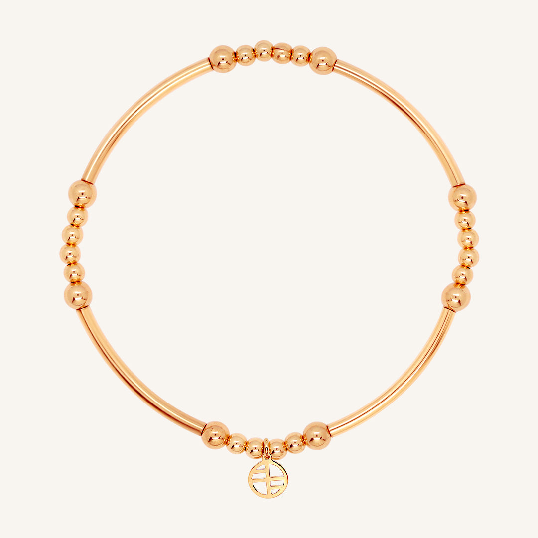 A rose-tone bracelet with spherical beads and a Francesca logo