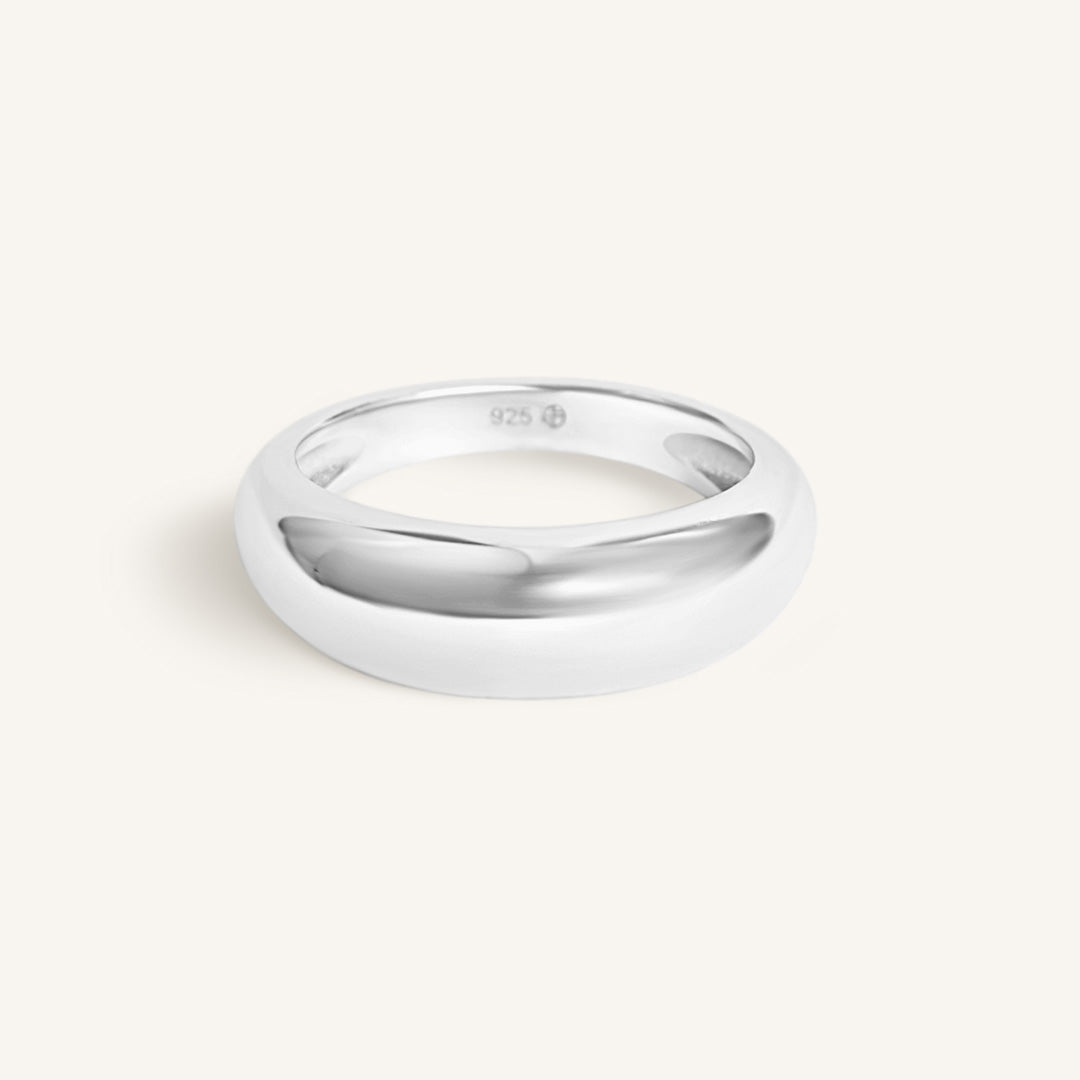 Silver ring on a light gray background