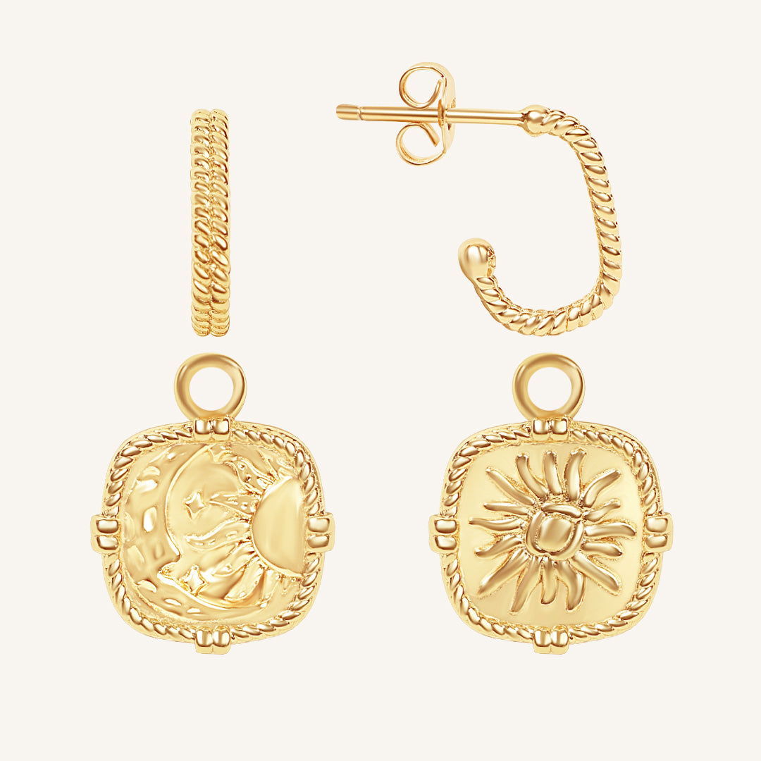 Gold earrings with intricate designs on a white background