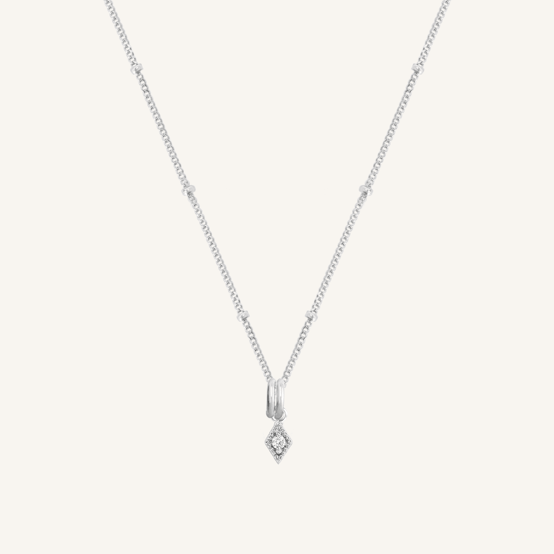 A delicate necklace featuring a small diamond charm pendant suspended from a silver-tone chain.